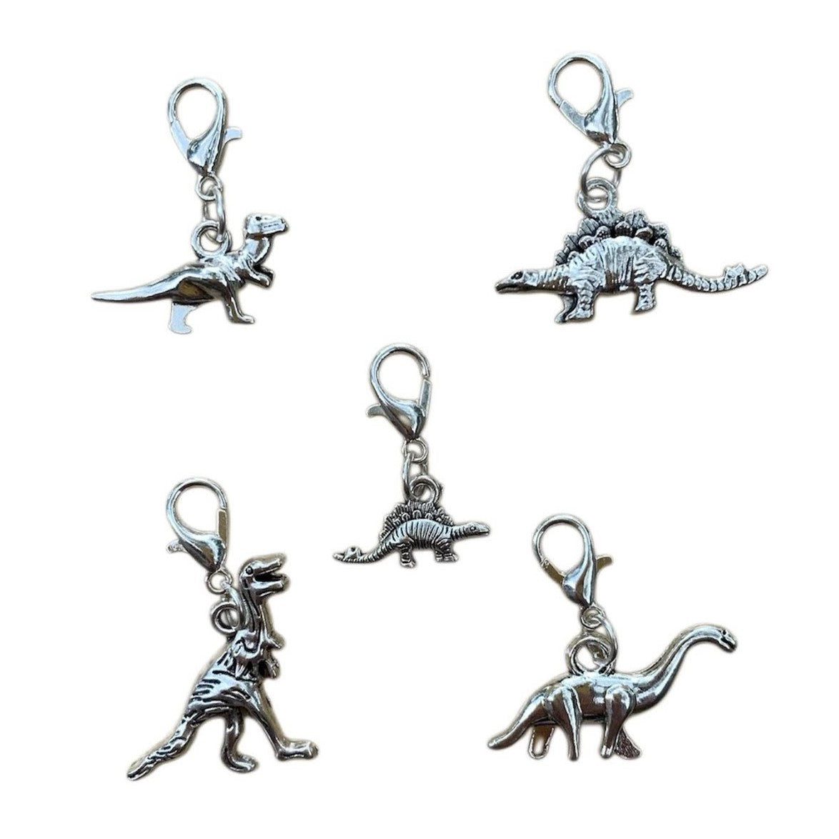 Wholesale Dinosaur Charms bundle of 5 unique dinosaur designs symbolizing strength, resilience, and timeless wonder, for jewelry making.