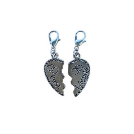 Two silver heart-shaped charms with 'Best Friends' text on a white background