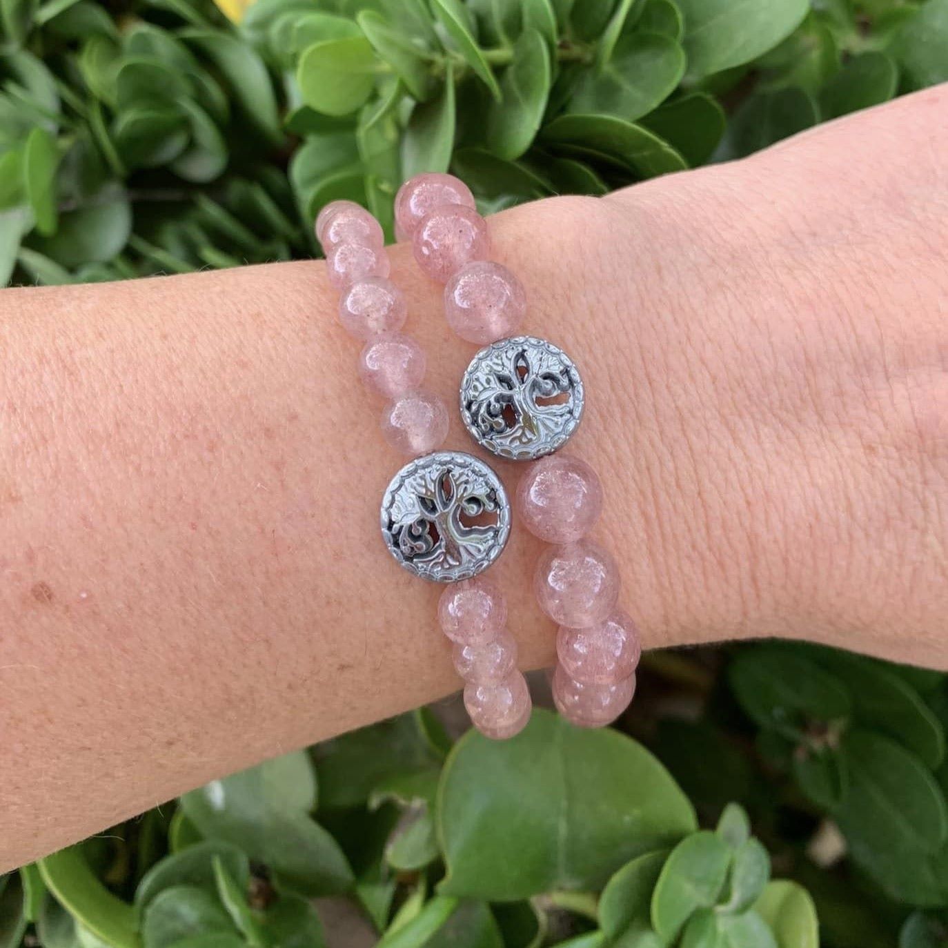 Healing crystal bracelets strawberry quartz pair on wrist