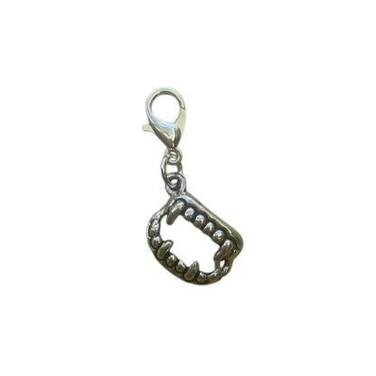 Vampire Teeth Charm symbolizing boldness, curiosity, and playful mischief, for spiritual necklaces and witchy crystal bracelets.